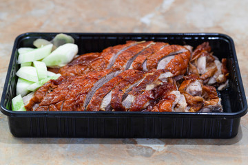 Roasted duck chinese style with vegetables on plate, selective focus, soft focus.