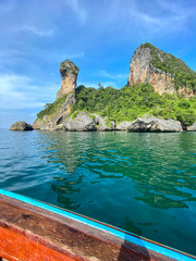 Sailing with a longtail private boat to Ko Poda Chicken island landscape with big rocks and turquoise water surface, Krabi, Thailand