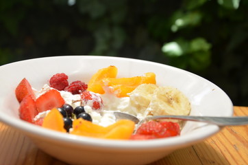 Healthy breakfast or snack curd with fruit and nuts. The concept of nutrition for weight loss. Keto breakfast. Keto lunch idea. cottage cheese or yogurt with berries on a window cup of coffee or tea