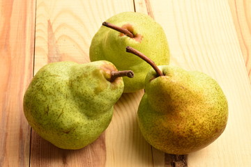 Juicy ripe, sweet, organic green pears, close-up, on a wooden table.