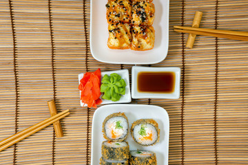 Sushi roll Japanese food, dish consisting of rice, salmon, tuna, sesame, soy, fish. Japan restaurant menu, California set. View from above