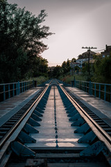 Fototapeta premium Train tracks at sunset vertical