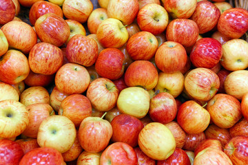 Fresh delicious organic red apples on the shelves of the hypermarket background.