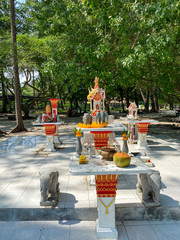 a small outdoor buddhist temple with elephants and flowers on the Ko Poda island, Krabi, Thailand