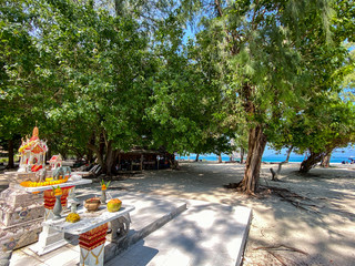 Fototapeta premium a small outdoor buddhist temple with elephants and flowers on the Ko Poda Chicken island, Krabi, Thailand