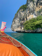 Sailing with a longtail private boat to Ko Poda island landscape with big rocks and turquoise water surface, Krabi, Thailand