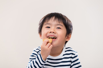 Asian kid boy eat cookie on white background