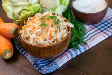 Homemade sauerkraut with carrot and spices on plate, sour white cabbage