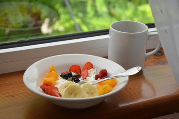 Healthy breakfast or snack curd with fruit and nuts. The concept of nutrition for weight loss. Keto breakfast. Keto lunch idea. cottage cheese or yogurt with berries on a window cup of coffee or tea