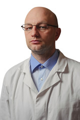 Portrait of a bald male doctor  on a white background. Man  dressed in white uniform, blue shirt, metal rim glasses. unshaven and looiking at the camera.
