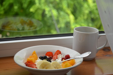 Healthy breakfast or snack curd with fruit and nuts. The concept of nutrition for weight loss. Keto breakfast. Keto lunch idea. cottage cheese or yogurt with berries on a window cup of coffee or tea