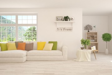 White living room with sofa and summer landscape in window. Scandinavian interior design. 3D illustration