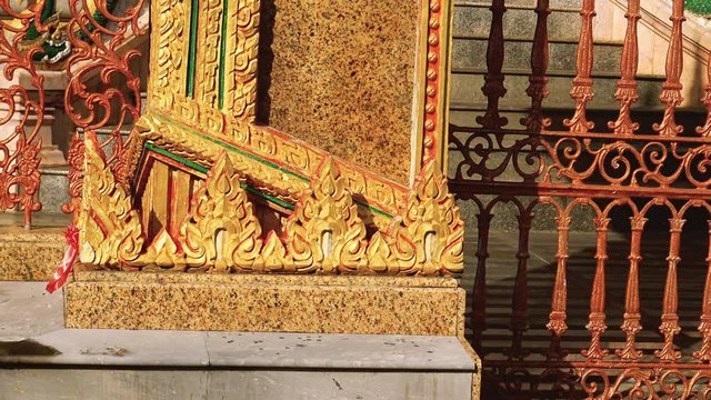 Traditional Thai temple ornamental facade decorations at walls of temple in Phuket, Thailand.