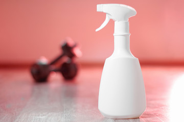 White packaging for liquid disinfectants for cleaning and prevention of viral infection. Plastic packaging stands on the floor on a blurry background