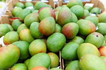 green mango fruit on the shelves. Colorful food, healthy lifestyle.