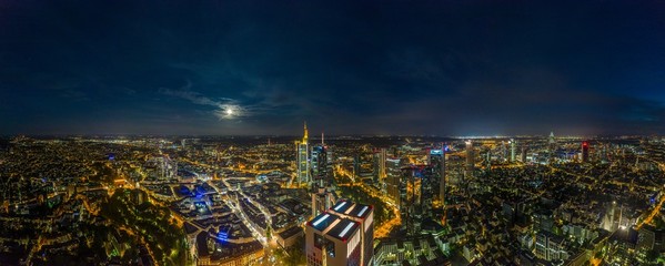 Aerial drone panorama of Frankfurt skyline at night with full moon and illuminated skyscrapers - obrazy, fototapety, plakaty