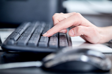 Female hands or woman office worker typing on the keyboard