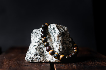 men stone bracelet on a rock isolated