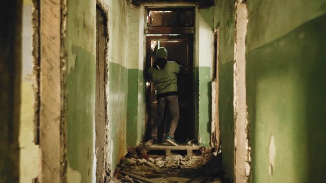 The guy runs through an abandoned house trying to find a way out. A long abandoned corridor