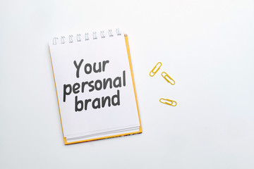 Hand lettering in a notebook your personal brand on a white background.