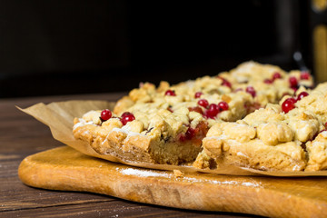 sliced ​​homemade grated pie with berries