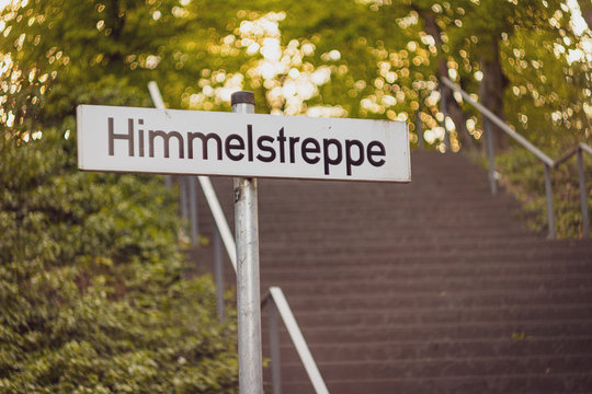 road sign in the park, Sky staircase in German language