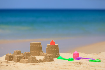 Fototapeta na wymiar Sand castle on the beach. Forms for sand