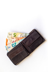 Old shabby wallet with euro money on a whitebackground