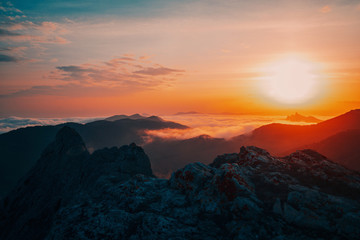 Beautiful sunset in the mountains in the fog