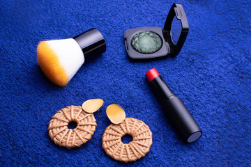 Women cosmetics and accessories on a blue background