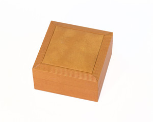 Orange beautiful box, decorated with leather, on a white background. Empty space. Stylized stock photos.