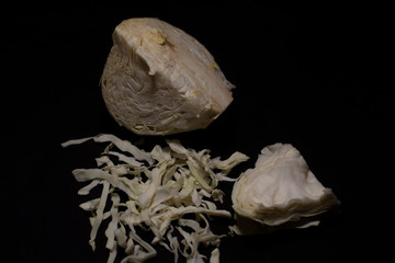 Cabbage cut in shredded form kept in a dark copy space background.