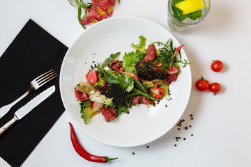Roast beef with salad mix. Mix of salads, cherry tomatoes, baked pepper, sun-dried tomatoes, roast beef, mustard sauce