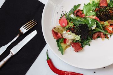 Roast beef with salad mix. Mix of salads, cherry tomatoes, baked pepper, sun-dried tomatoes, roast beef, mustard sauce