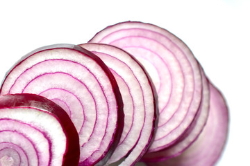 Red sliced delicious onion on a white plate
