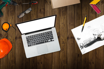 Workplace of architect - Architectural project, blueprints, blueprint rolls and laptop, pen on plans. Engineering tools and gadgets view from the top. Construction background.