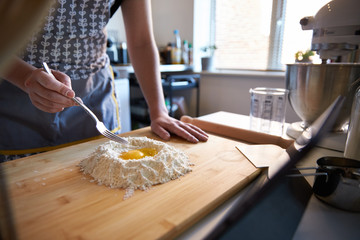 Anonymous Person Making Fresh Pasta At Home in The Kitchen, Watching A Video Recipe