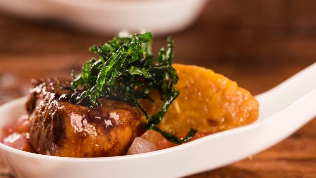 Slide shot Pork mignon with creamy canjiquinha and vinaigrette in a spoon. Taste gastronomy finger food with smoke.