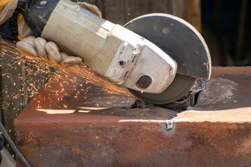 Metal processing with a manual electric grinder.