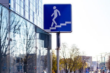 A sign indicating an underpass in the city center.