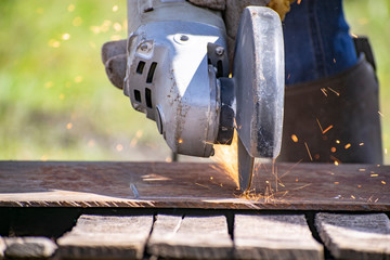 Metal processing with a manual electric grinder.