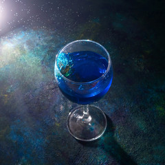 Blue cocktail on dark background.