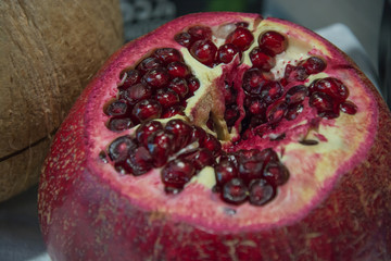 Pomegranate fruit in the foreground, a prize for the palate