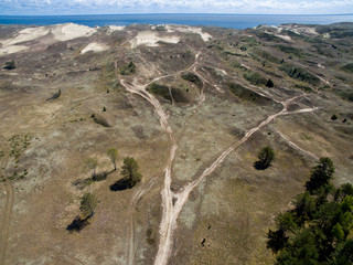 Aerial view with dunes, forest and sea in Curonian spit on a sunny day photographed with a drone. The Curonian Spit lagoon. Gray Dunes, Dead Dunes. 