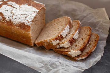 Fragrant and crunchy sliced bread on parchment in the kitchen. Homemade fresh bread without yeast.