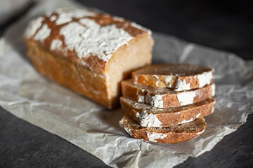 Fragrant and crunchy sliced bread on parchment in the kitchen. Homemade fresh bread without yeast.