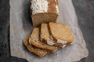 Fragrant and crunchy sliced bread on parchment in the kitchen. Homemade fresh bread without yeast.