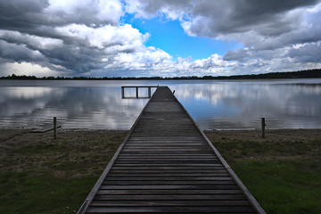 Naklejka premium wooden bridge over lake