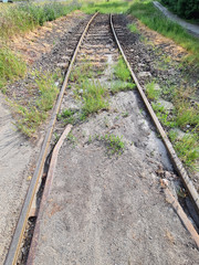 Obraz premium Abandoned railway track in the grass