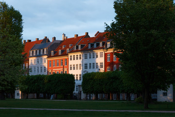 Historical city centre of Copenhagen Denmark. Cityscape with Rosenborg King's garden. Old buildings with golden colorful sunset in background.